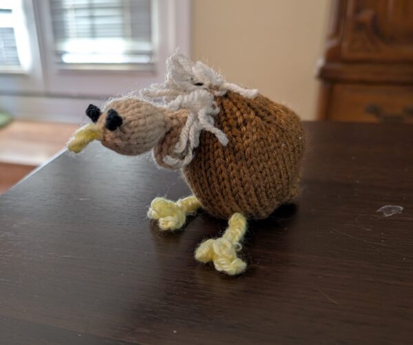 A tiny knitted vulture